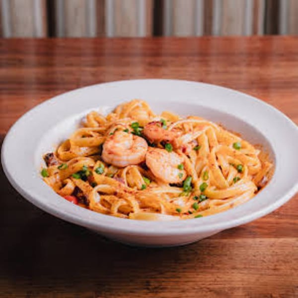 Unwined Kitchen & Bar's shrimp linguine pasta dish with creamy sauce and green onions.
